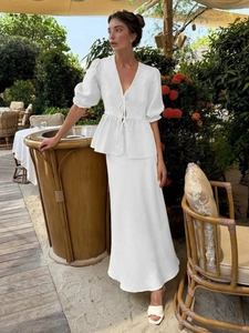 Elegant white two-piece set featuring a V-neck puff sleeve crop top and high waist maxi skirt