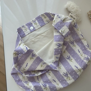 Detail of lavender floral cotton bag with magnetic clasp and internal pocket