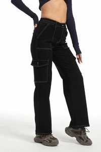 Detailed view of high-waist black cargo pants featuring contrast white stitching and pockets