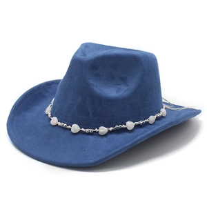 Close-up of a blue suede cowboy hat featuring a bohemian heart bead decorative band