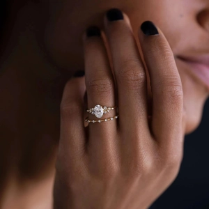 Close-up of S925 silver gold ring set featuring a large oval cubic zirconia on hand