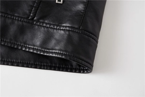 Macro shot of double-needle stitching and silver metal zipper on black leather jacket