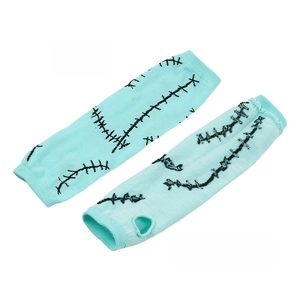 Close-up of cyan knitted arm warmers with black stitch patterns and thumb hole detail