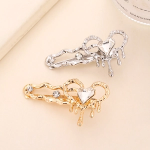 Elegant heart-shaped cat eye stone hair clips in gold and silver with melting metal effect