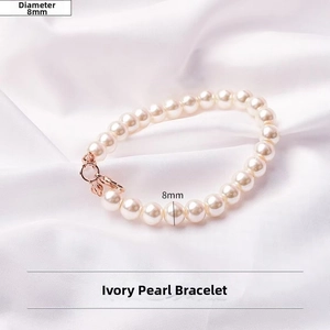 Close-up of 8mm cream-white pearl chain with elegant rose gold clasp and leaf charms