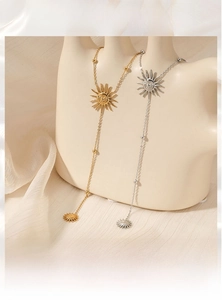 Detail of sun face necklaces in gold and silver finish with PVD plating on a mannequin