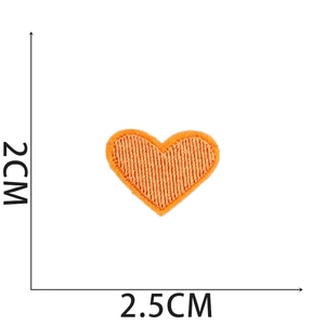 Detailed view of orange embroidered heart patch with 2.5cm x 2cm measurement indicators