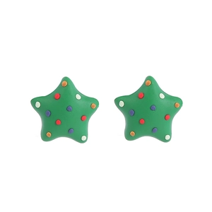 Detailed macro shot of green star-shaped clay earrings with festive colorful dots pattern