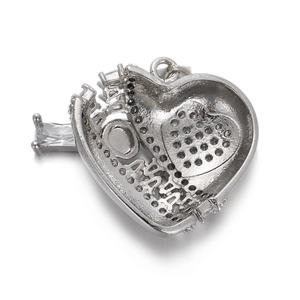 Macro view showing the silver heart pendant back with hollow grid design and clear stone