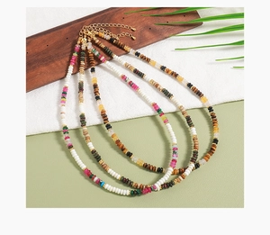 Detail of four colorful bohemian handmade beaded necklaces with natural tiger eye stones