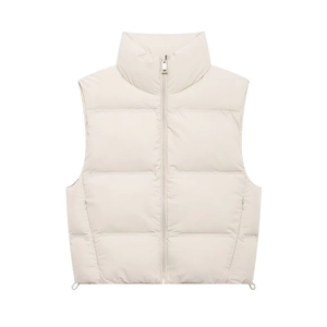 Detail of high stand collar and metal zipper on cream puffer vest with quilted finish