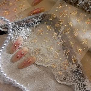 Elegant fireworks nail art stickers with gold foil details and starry gradient patterns