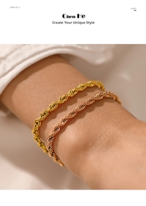 Close-up of gold and rose gold twisted rope chain bracelets on a woman's wrist