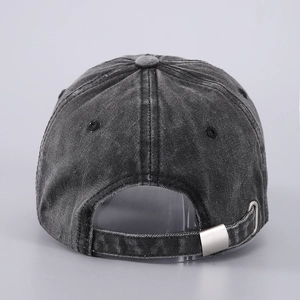 Detail view of washed denim baseball cap with adjustable metal buckle on the back