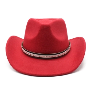 Close-up of red woolen cowboy hat featuring a brown belt with silver star-shaped rivets