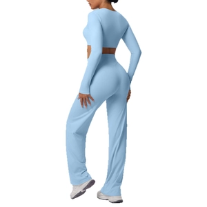 Women's baby blue ribbed sports set featuring long sleeve top and flared yoga pants