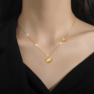 Titanium steel necklace with layered gold butterfly pendants worn on a female neck