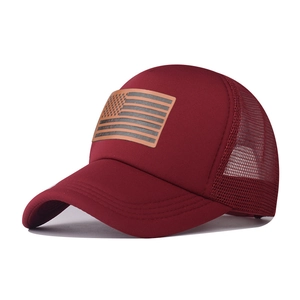 Detail of burgundy trucker hat with breathable mesh and American flag leather patch