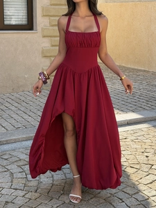 Detail of red halter dress featuring a stylish high-low irregular hem and waist pleats