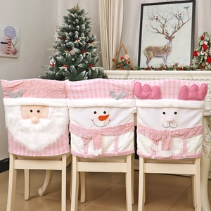 Pink Christmas chair covers with Santa, snowman and reindeer figures in home setting