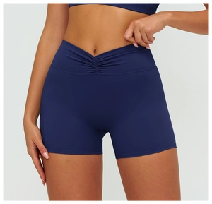 Close-up of high-waist yoga shorts with V-shaped crossover waistband and ruched detail