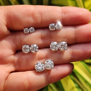 Five pairs of various sized round moissanite stud earrings in 925 sterling silver settings