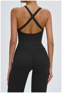 Close-up of black yoga sports bra with cross-back strap design and high-waist leggings