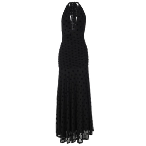 Detail of black polka dot mesh dress featuring a deep V-neck and halter neck design
