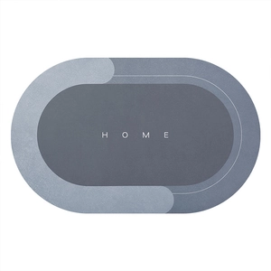 Minimalist grey oval absorbent bathroom mat with HOME lettering and non-slip design