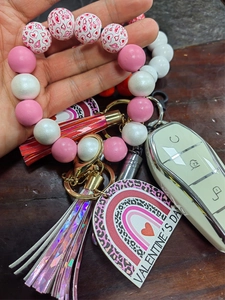 Detailed macro view of Valentine's Day silicone bead wristlet with tassels and heart tag