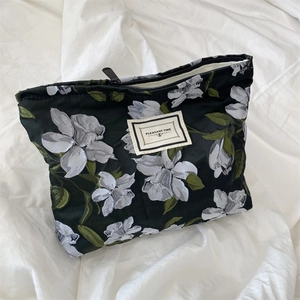 Macro shot of floral jacquard fabric texture and Pleasant Time label on shoulder bag