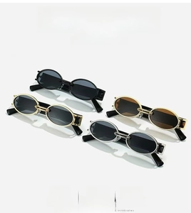 Close-up of retro oval sunglasses showing metal frames in black, gold and silver