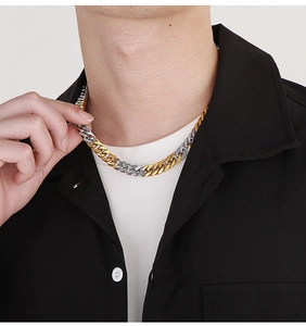 Close-up of two-tone gold and silver Cuban link necklace on model neck