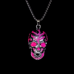 Close-up of hip hop skull pendant with glowing pink patterns and silver chain