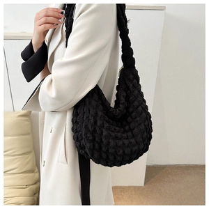 Close-up of black popcorn texture material on a stylish large shoulder tote bag