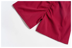Detailed close-up of wine red high-waist yoga shorts showing scrunch butt seam and fabric texture