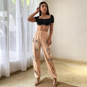 Detail of slim crop top and drawstring joggers with side graphic prints on the leg