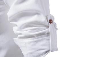 Macro shot of white cotton shirt sleeve cuff showing fine fabric texture and button detail