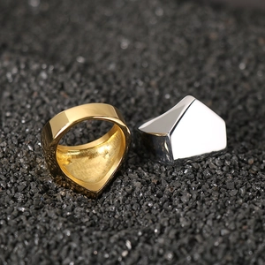 Minimalist geometric pyramid rings in gold and silver stainless steel on black stones