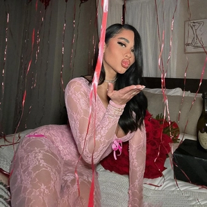 Detailed view of pink floral lace texture on long-sleeve V-neck sheer bodysuit