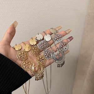 Detail of bohemian gold and silver head chain hair jewelry with crescent moon charms