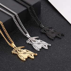Detailed close-up of grim reaper necklaces in gold, silver, and black finish on Cuban chains
