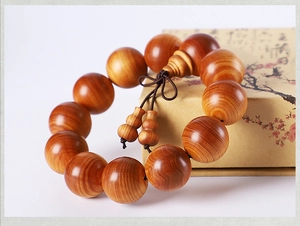 Detail of Thuja cedar wood beads with natural cloud grain and a small gourd pendant
