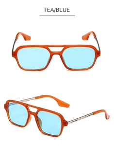 Detail of vintage double-bridge sunglasses with amber frames and light blue lenses