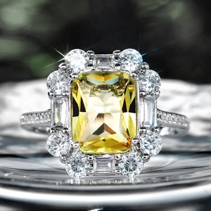 Luxurious yellow emerald-cut zircon ring with halo diamond setting and pavé band for women