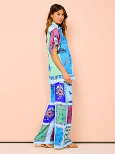 Detailed side view of colorful printed satin lounge set with shirt and wide-leg pants
