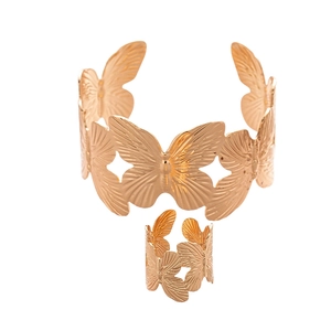 Minimalist gold butterfly jewelry set featuring textured open bracelet and matching ring