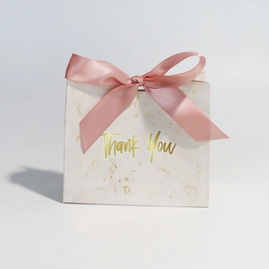 Detail of marble pattern gift box with pink ribbon bow and golden Thank You text