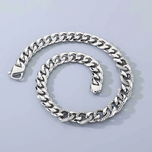 Detailed close-up of a 13mm silver cuban link chain with sparkling diamond-set accents