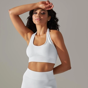 Detail of white seamless knitted sports bra and high-waisted leggings with ribbed texture